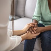 psychologist hold hands of patient